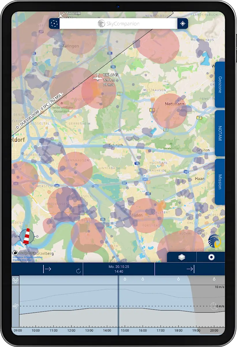 Tablet with screenshot of app SkyCompanion showing a map with geo-zones and a time slider element with weather data.