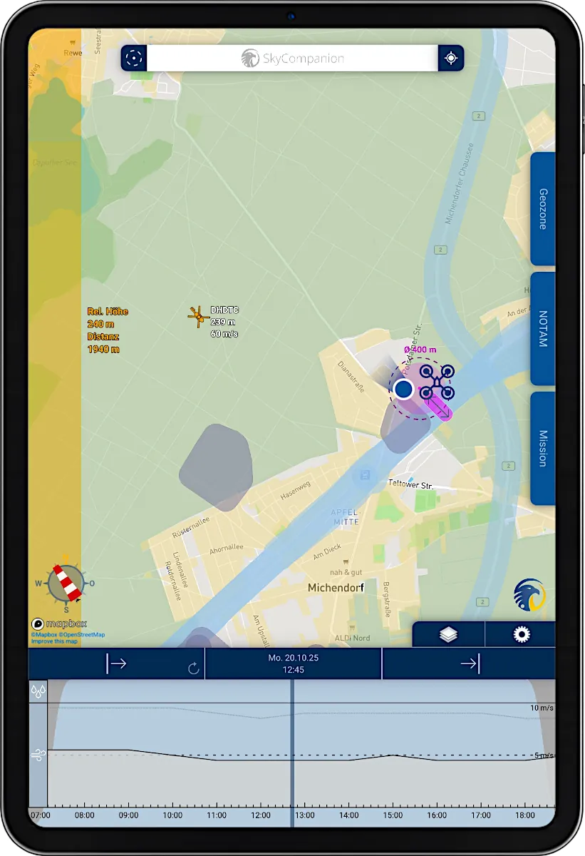 Tablet with screenshot of app SkyCompanion showing a map with air traffic, drones and warnings and a time slider element with weather data.