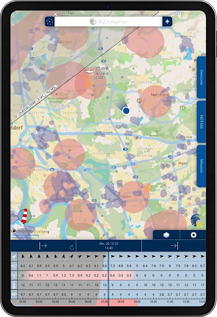 Tablet with screenshot of app SkyCompanion showing a map with geo-zones and a time slider element with weather data.
