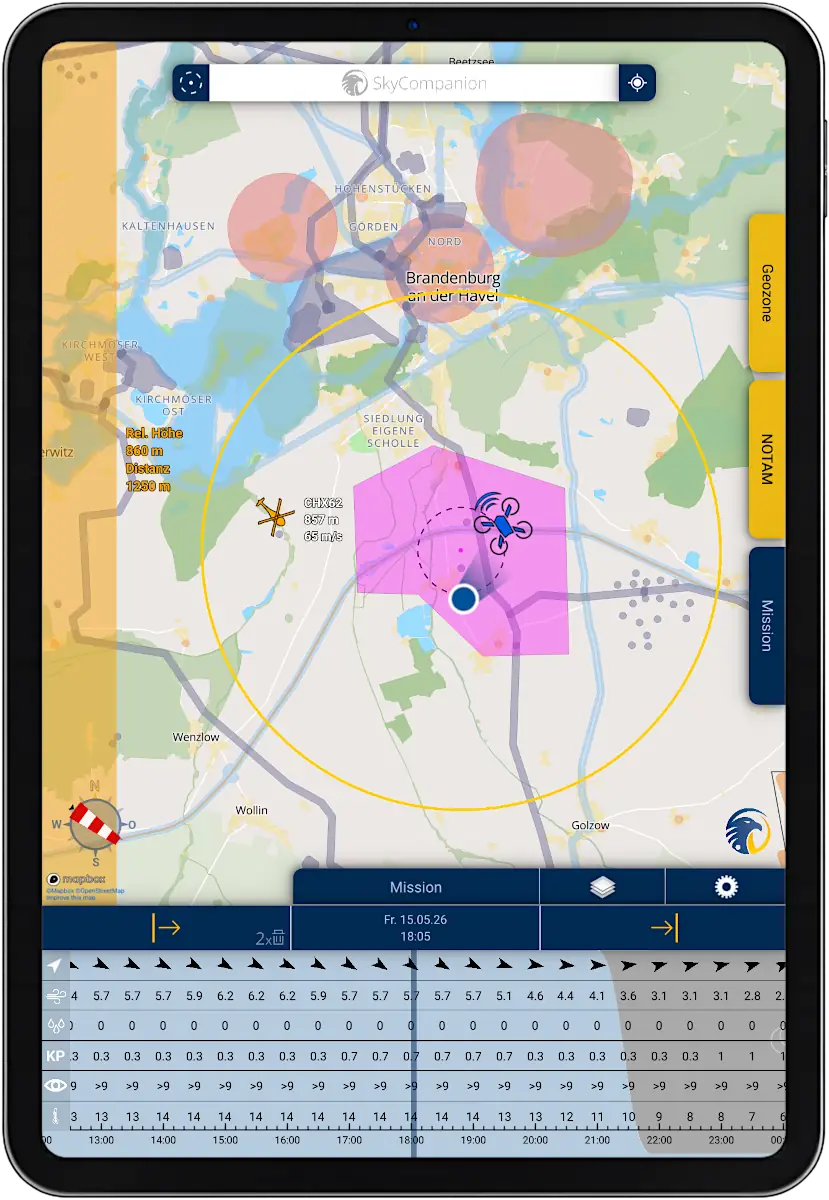 Tablet with screenshot of app SkyCompanion showing a map with air traffic, drones and warnings and a time slider element with weather data.